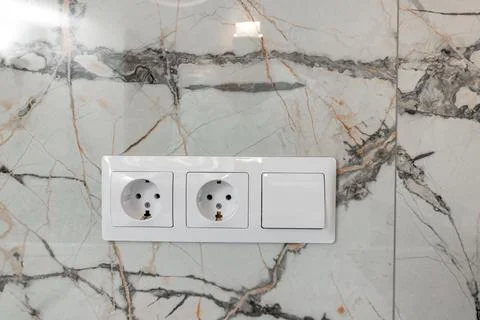 White electrical outlets on a white wall Stock Photos