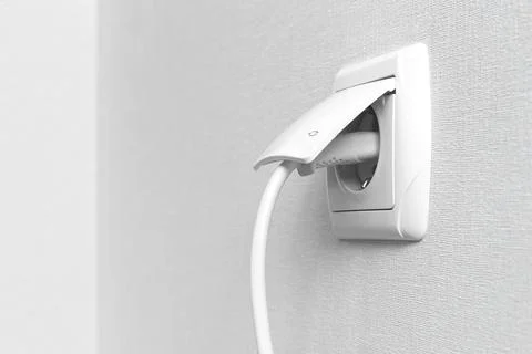 White electrical plug in the electric socket on a wall, interior photo Stock Photos