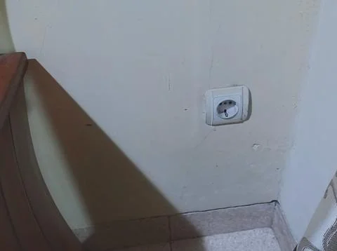 White electrical plug in the home wall Stock Photos