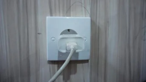 White Electrical Plug in Wall Socket 스톡 사진