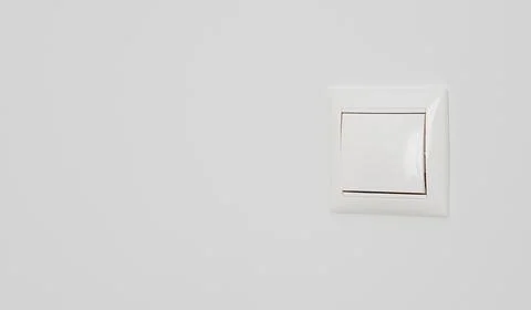 White electrical switch on white plastered wall, close-up with copy space Stock Photos