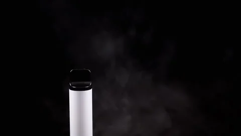 White Electronic Cigarette or Vape in Smoke on a Black Background in Empty Space Stock Footage 263824121