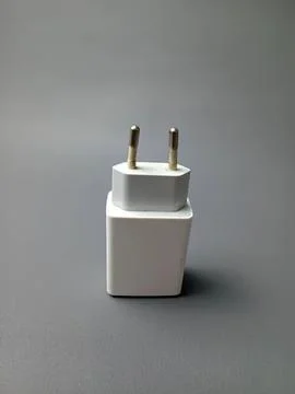 White electronic plug adapter on gray background Stock Photos