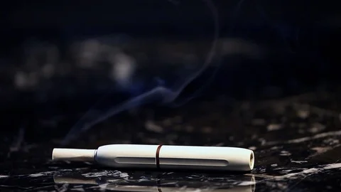 White electronic smoke device dark marble background nobody hd footage Stock Footage 102375415