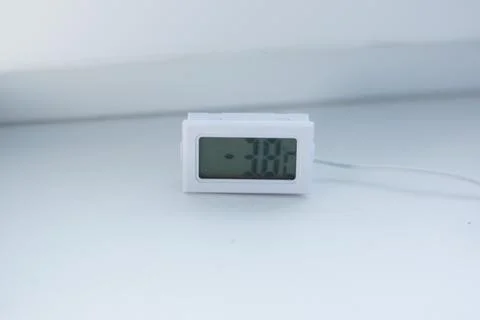 White electronic temperature meter on a white background Stock-Fotos