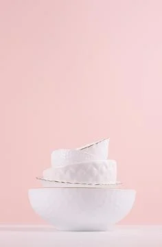 White elegant plates in stack with thin golden bezel, bizarre texture on whit Stock Photos