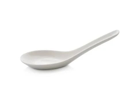 White empty ceramic spoon for soup on white background Stock Photos