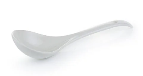 White empty ceramic spoon on white background Stock Photos