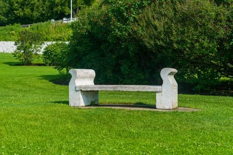 White empty concrete bench in a public park. Stock Photos