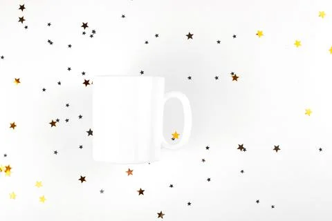 White empty cup mockup on light background with gold stars. Minimalistic mug Stock Photos