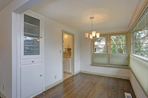 White empty dining area with new hardwood floor. Stock Photos