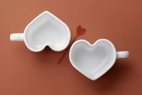 White empty heart-shaped cups on a red background.Top view.Mockup, template Stock Photos