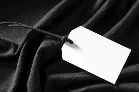 White empty label on black cloth. High quality and resolution beautiful photo Stock Photos
