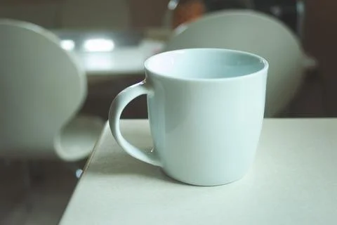 White empty mug standing on the counter Stock Photos