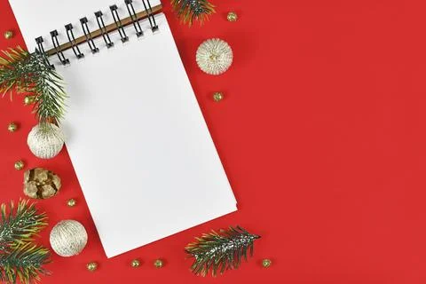 White empty notebook surrounded by Christmas decoration in corner of red 스톡 일러스트