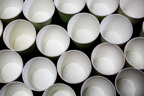 White empty paper cups on a black background. Texture of cups Stock Photos