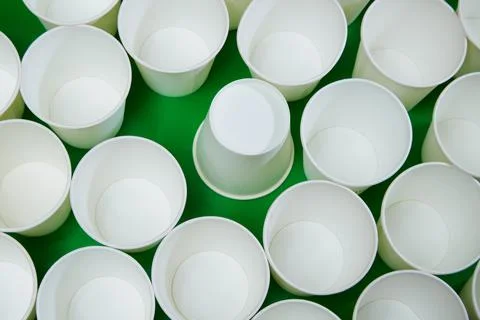 White empty paper cups, one of which is turned upside down. One of all, error Stock Photos