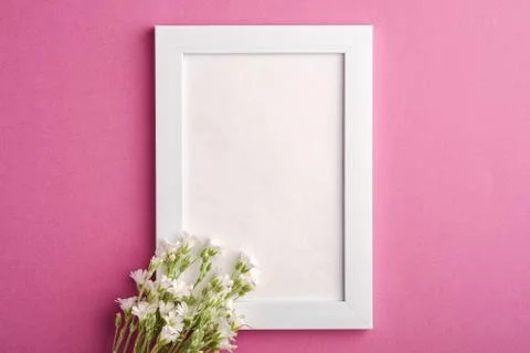 White empty photo frame mockup with mouse-ear chickweed flowers Stock Photos
