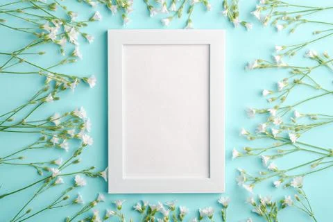 White empty photo frame mockup with mouse-ear chickweed flowers Stock Photos