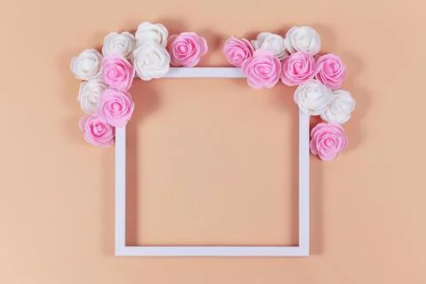 White empty picture frame with foam rose flowers Stock Photos