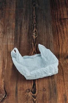 White empty plastic bag floating over wooden background Foto stock