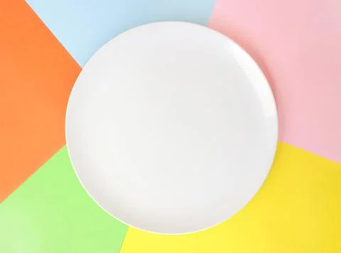 White empty plate on colored background, place for text, top view Stock Photos