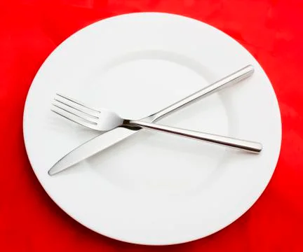 White empty plate with fork and knife Stock Photos
