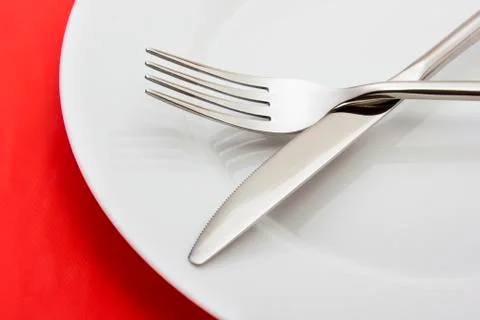 White empty plate with fork and knife Stock Photos