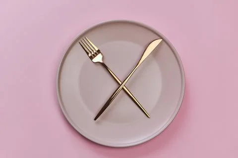 White empty plate with fork and knife isolated on white Stock Photos
