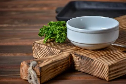 White empty plate for soupe with spoon on the wooden background. Copy text. Stock Photos