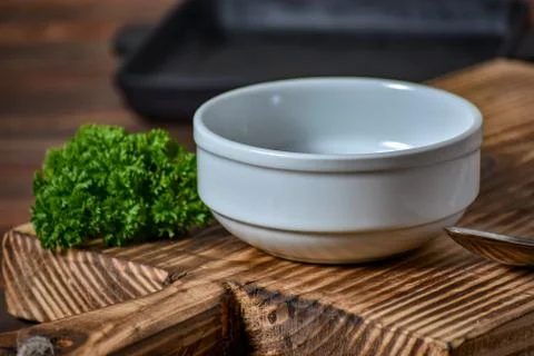 White empty plate for soupe with spoon on the wooden background. Copy text. Stock Photos