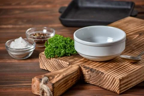 White empty plate for soupe with spoon on the wooden background. Copy text. Stock Photos