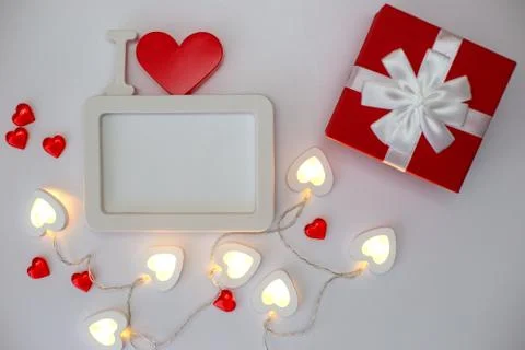 A white empty rectangular photo frame with a red heart and red gift box Stock Photos