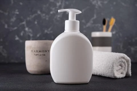 White empty shampoo or lotion bottle for mock-up in modern dark bathroom inte Stock Photos