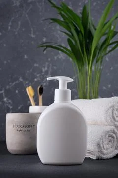 White empty shampoo or lotion bottle for mock-up in modern dark bathroom inte Stock Photos