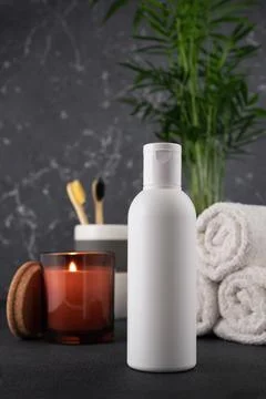 White empty shampoo or lotion bottle for mock-up in modern dark bathroom inte Stock Photos