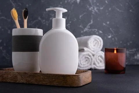 White empty shampoo or lotion bottle for mock-up in modern dark bathroom inte Stock Photos