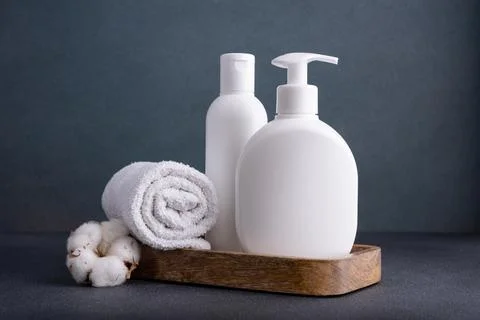 White empty shampoo or lotion bottle for mock-up in modern dark bathroom inte Stock Photos