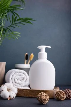White empty shampoo or lotion bottle for mock-up in modern dark bathroom inte Stock Photos