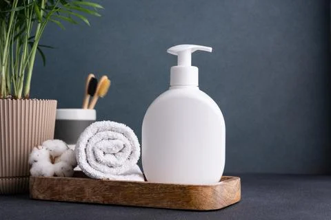 White empty shampoo or lotion bottle for mock-up in modern dark bathroom inte Stock Photos