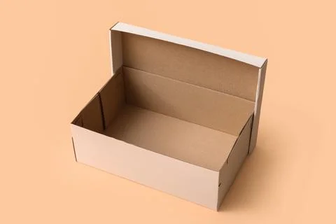 White empty shoebox on beige background Stock Photos