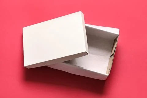 White empty shoebox on red background Stock Photos