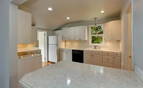 White empty simple old kitchen interior with hardwood floor and white cabinet Stock Photos
