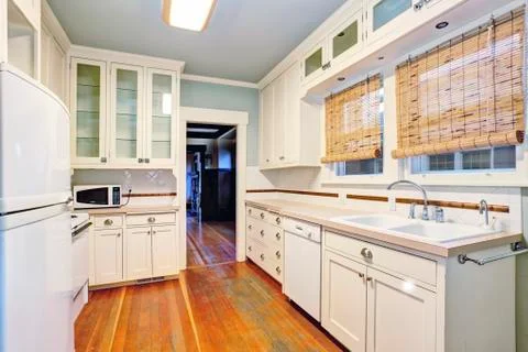 White empty simple old kitchen room with pastel blue ceiling  and hardwood fl Stock Photos