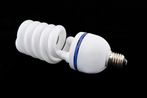 White energy saving bul or Illuminated light bulb on black background Stock Photos