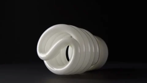 White energy saving bulb rotates on a black background Video stock 131050138