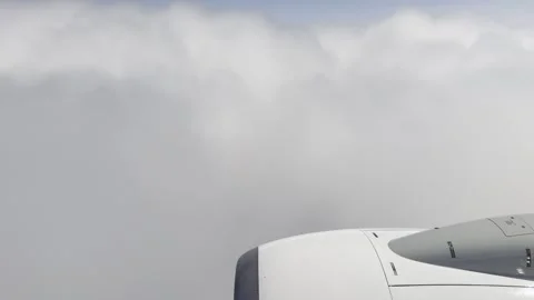 White Engine Nacelle Sinking Into a Towering Bank of Cloud 動画素材 336219679