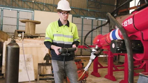 White engineer test and control robotic arm in mechanical manufacturing factory. Stock Footage 227303825