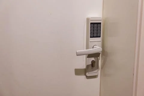 White entry door with access keypad and small display Stock Photos