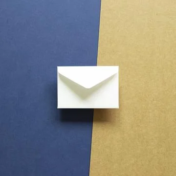 White envelope on blue and brown background. top view, copy space Stock Photos